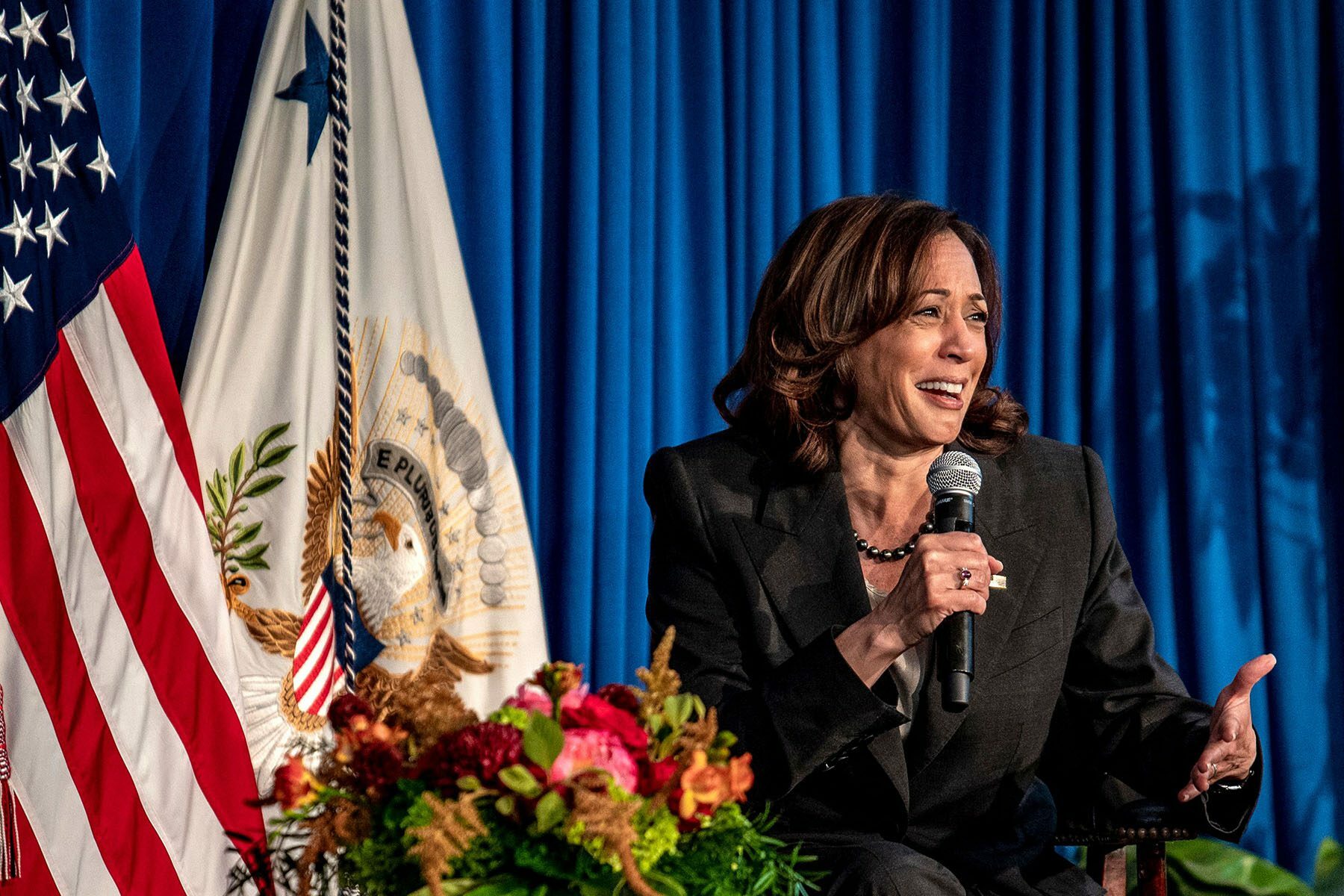 Kamala Harris speaks into a microphone during a discussion on reproductive rights.