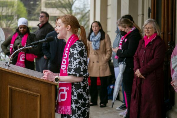 Mallory McMorrow speaks at podium during an abortion rights rally on the steps on the Michigan State Capitol