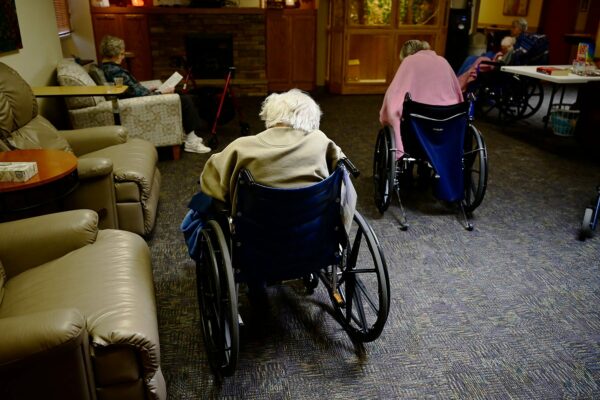 Residents in wheelchairs take a break at a Colorado nursing home.