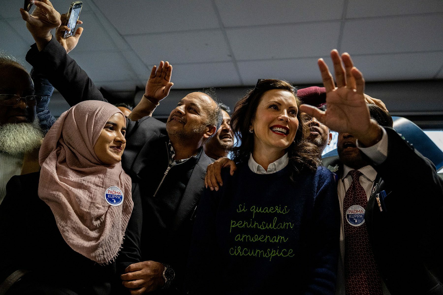 Gretchen Whitmer laughs and takes pictures with supporters at the conclusion of a campaign rally.