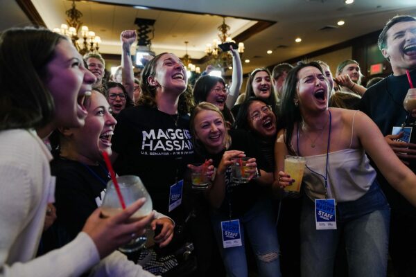 Supporters jump for joy and cheer during an election night watch party for Sen. Maggie Hassan.