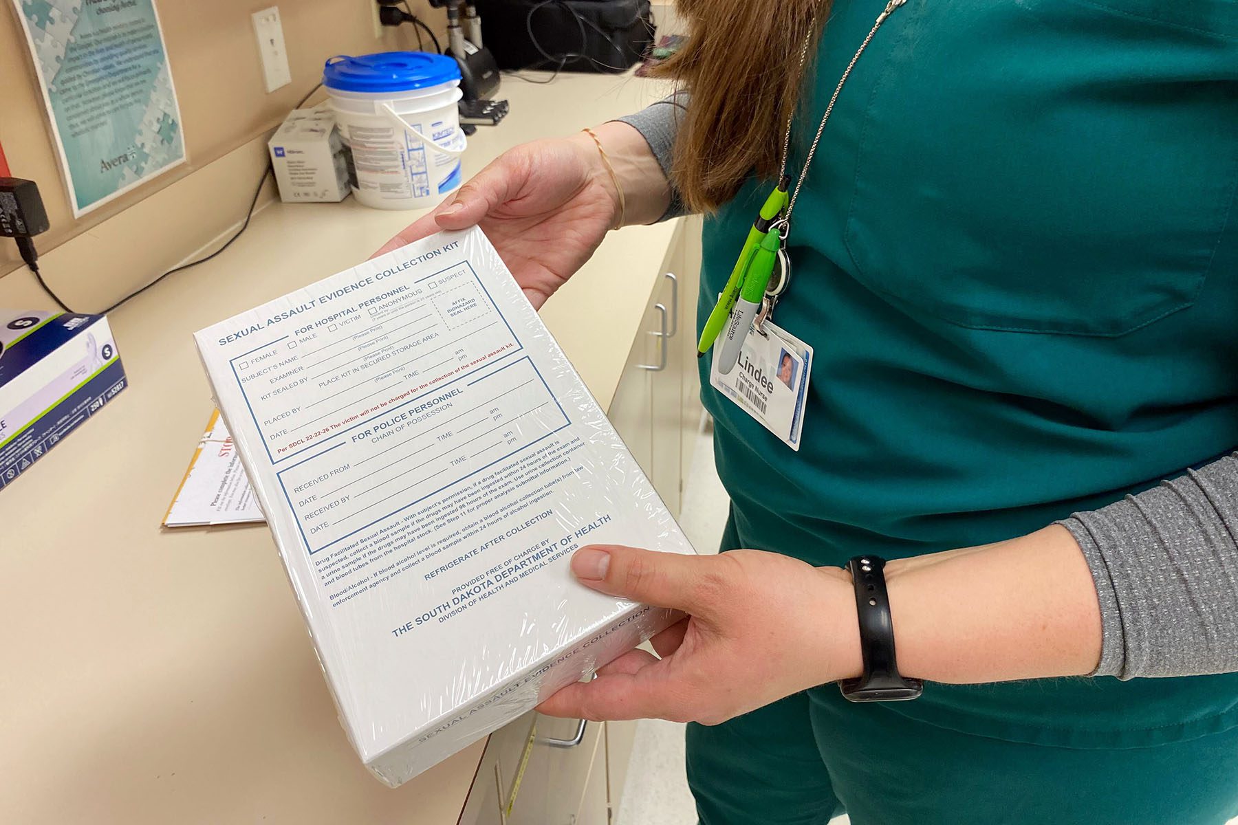 Nurse Lindee Miller holds a standard sexual assault evidence collection kit.