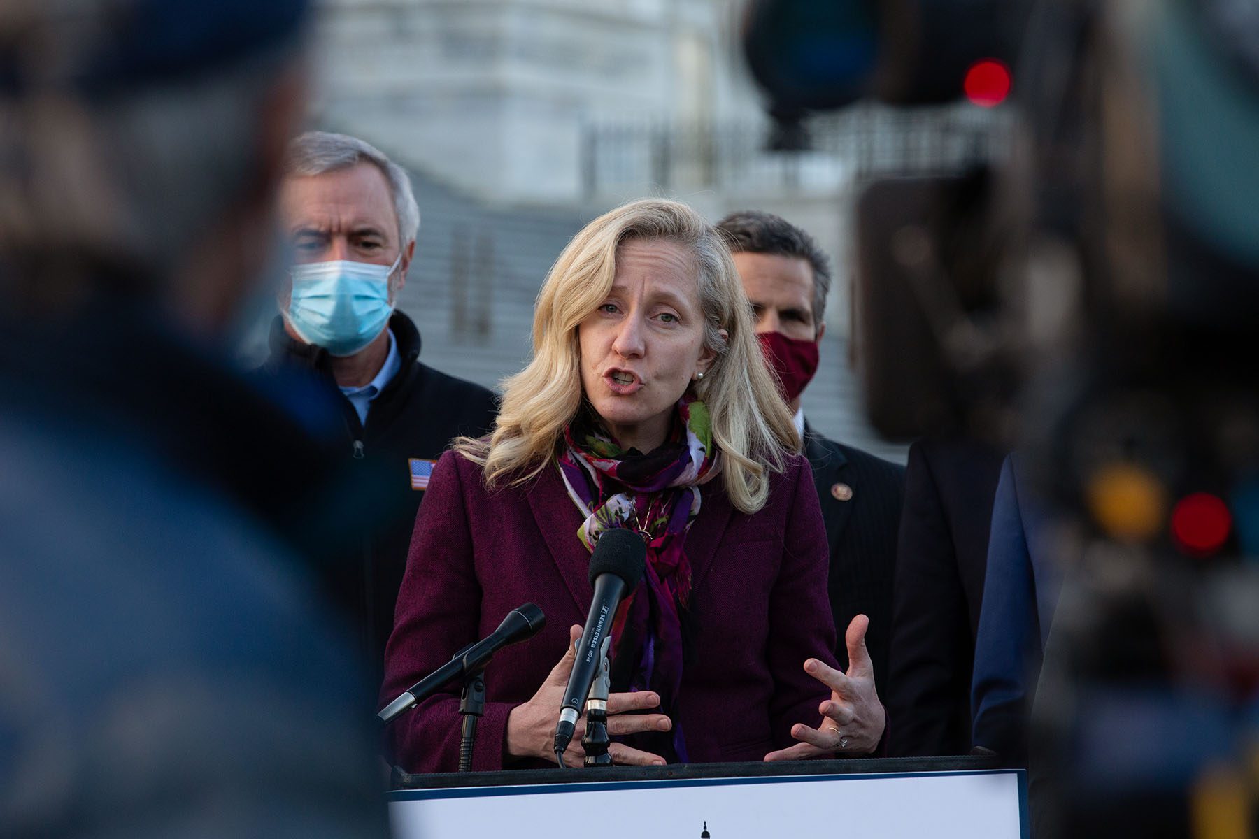 Rep. Abigail Spanberger speaks with members of the Problem Solvers Caucus outside the U.S. Capitol.