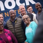Sen. Raphael Warnock takes photos with supporters after a Get Out the Vote rally.