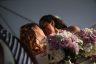 Two women kiss after their wedding ceremony.