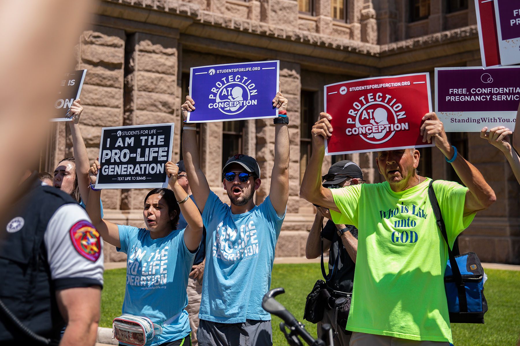 Anti-abortion protesters hold signs that read "protection at conception," and "I am the pro life generation" outside the Texas Capitol.