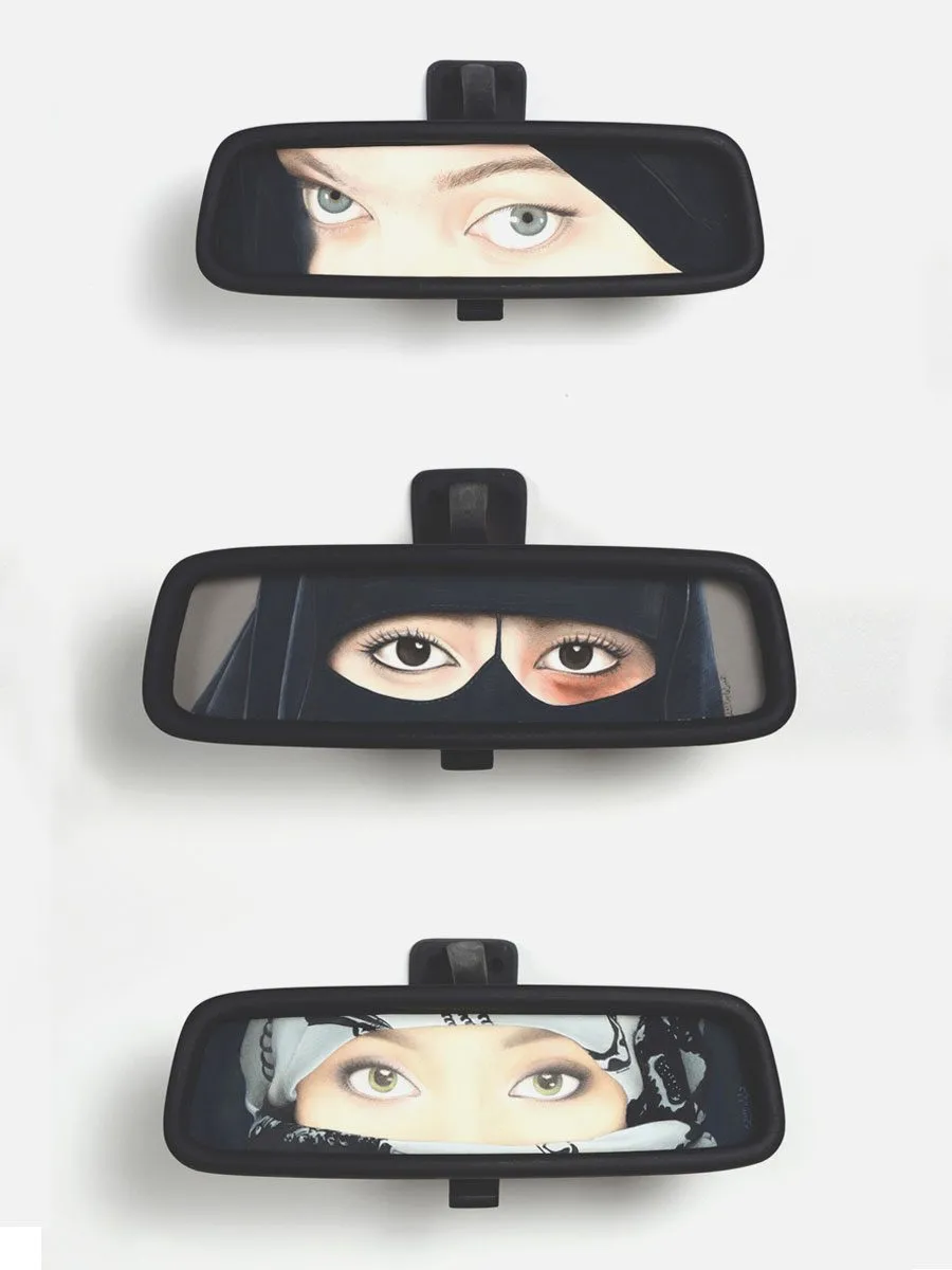 A set of three rear view mirrors showing the eyes of Muslim women wearing niqabs.