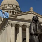 A statue in front of the Oklahoma State Capitol building.