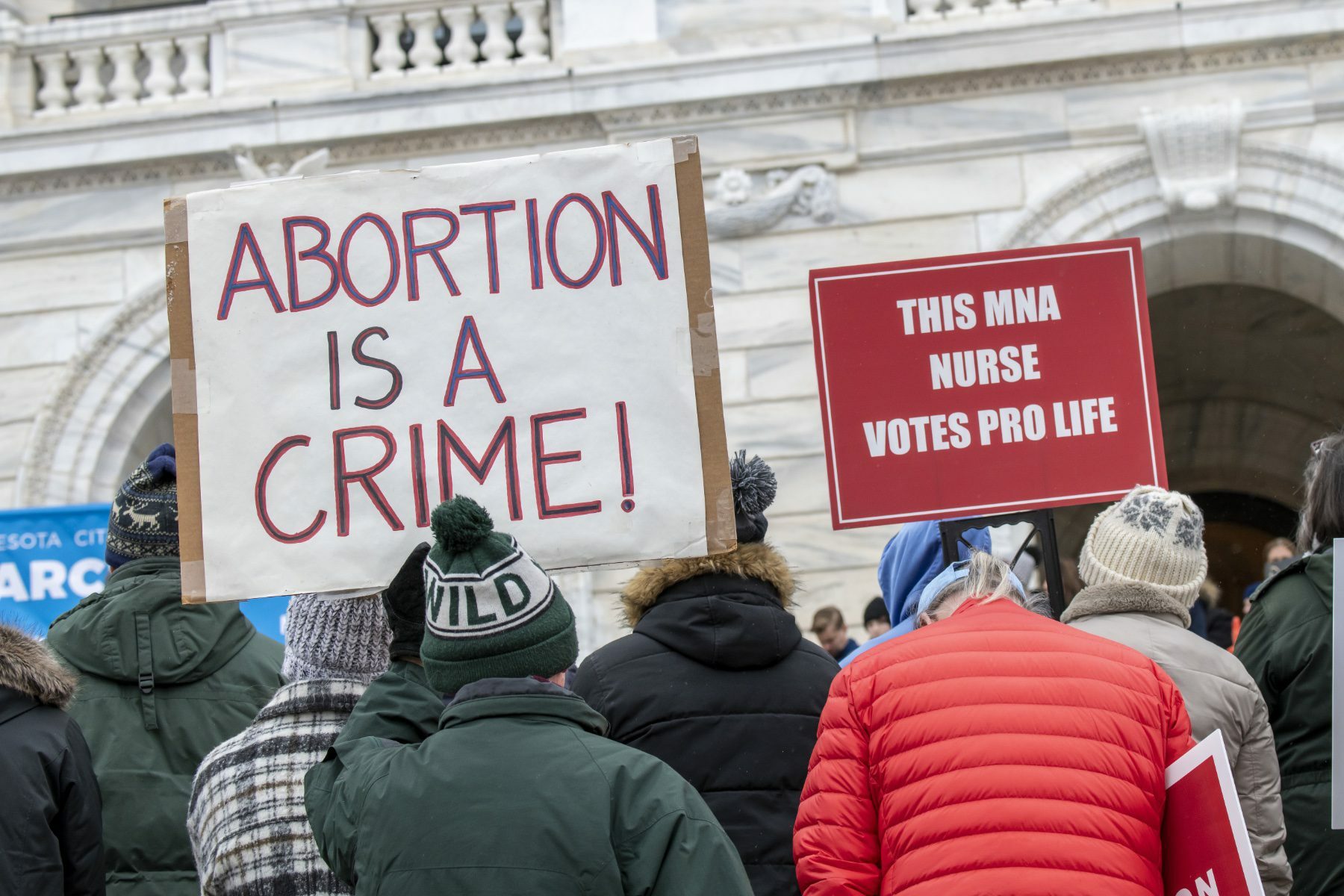 Anti-abortion protesters hold a sign that reads 