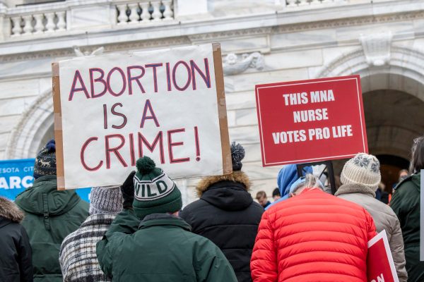 Anti-abortion protesters hold a sign that reads 