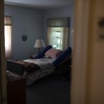 A room shows a bed in a nursing home.