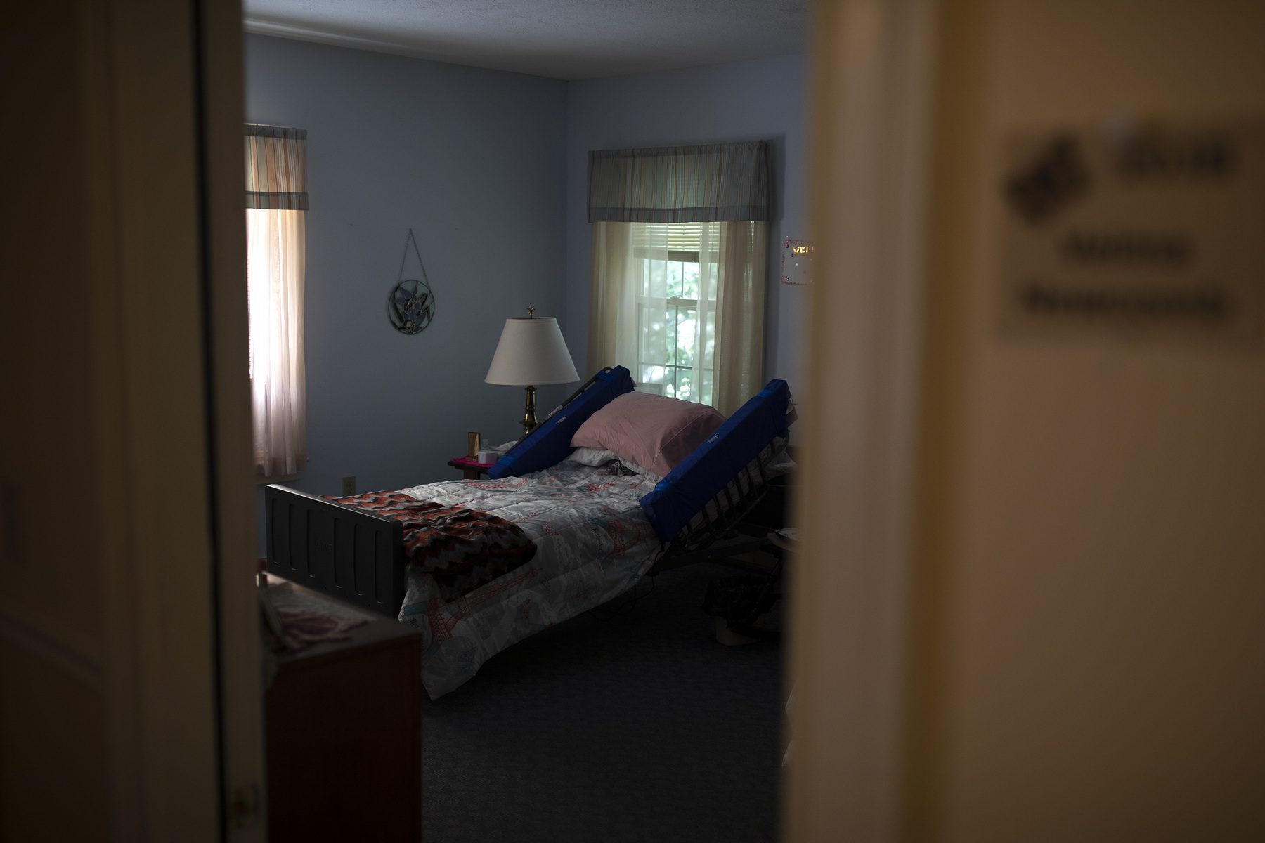 A room shows a bed in a nursing home.