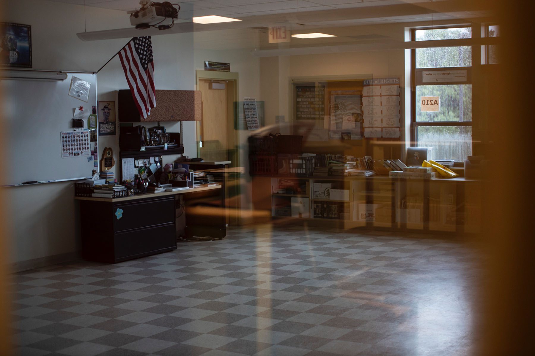 An American flag is seen in an empty classroom.