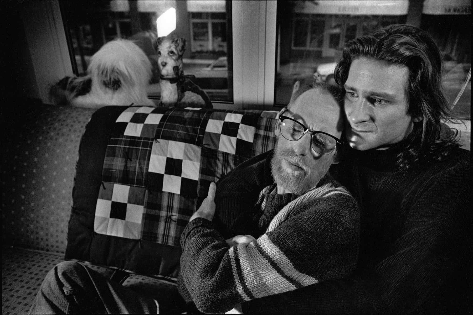 George Hill and his partner, Adrian Kolb, hold each other while on a couch in Hill’s room at the Bailey-Boushay House.