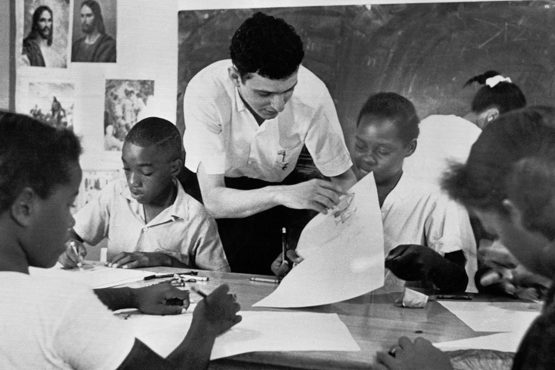 A volunteer from New York City, teaches a class to young black students at a freedom school in mississippi.