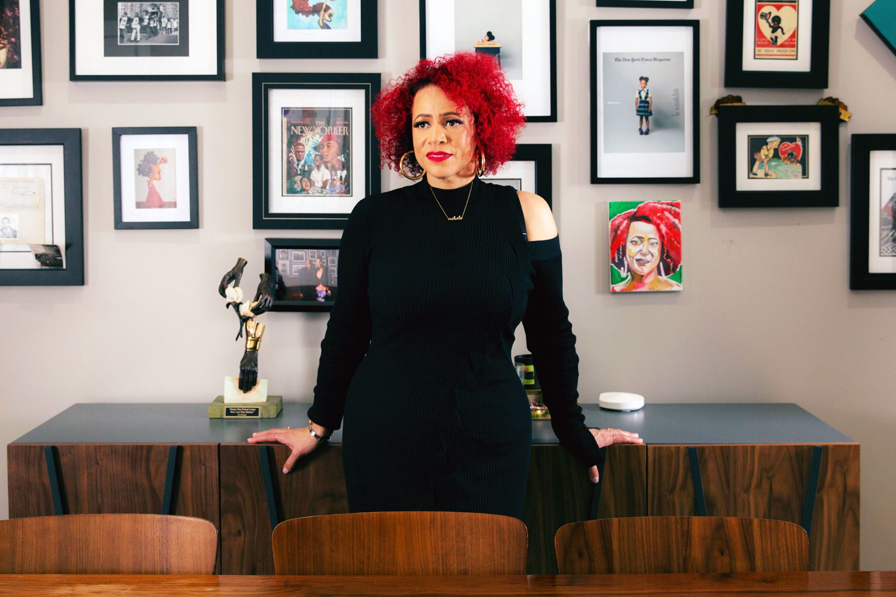 Nikole Hannah-Jones poses for a portrait at home in front of a gallery wall.