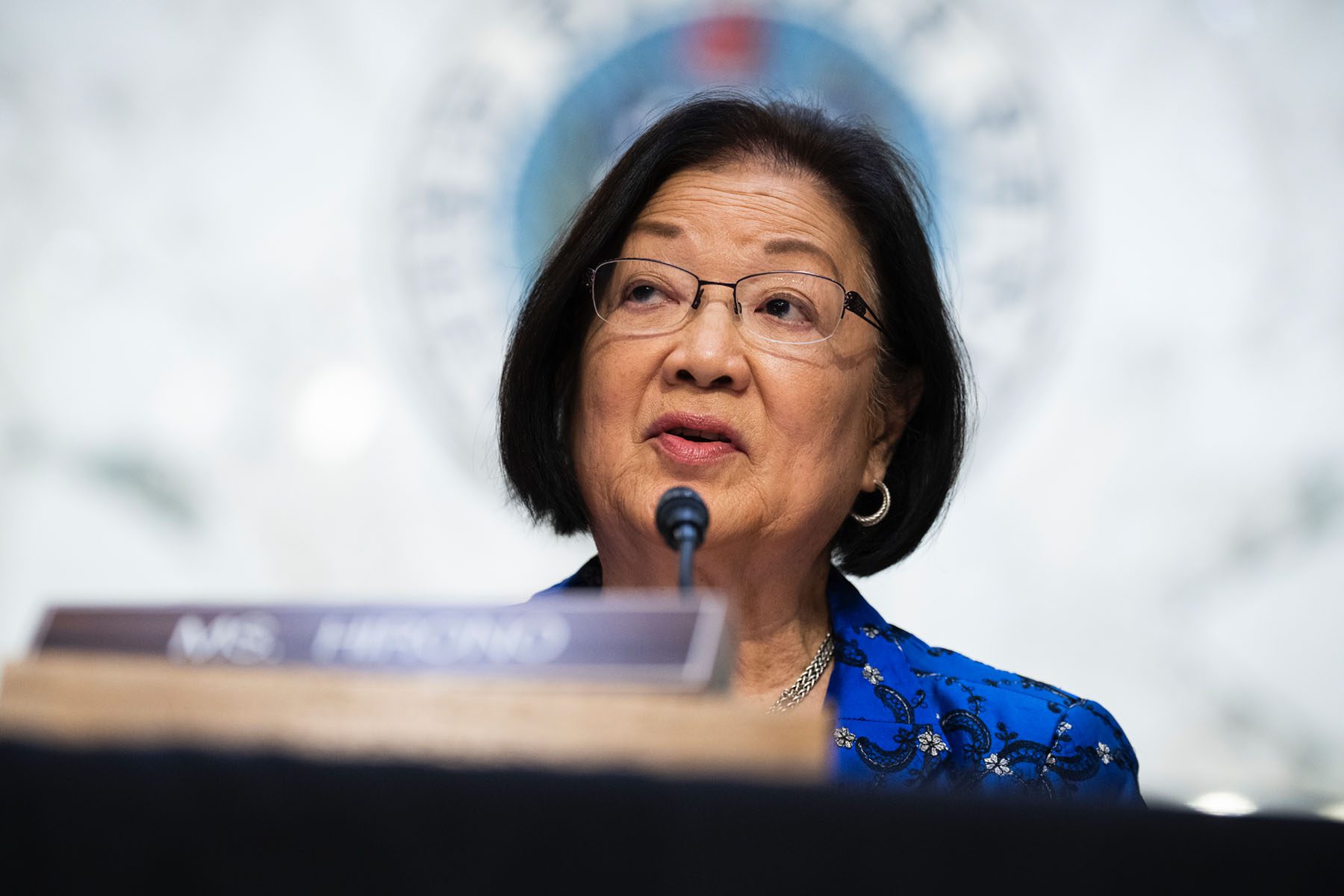 Sen. Mazie Hirono speaks into a microphone on Capitol Hill.