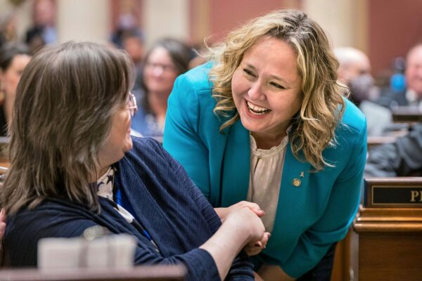 Emma Greenman greets a colleague at the Minnesota State Capitol.