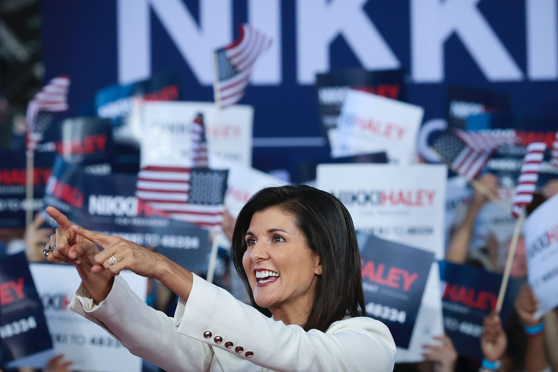 Republican presidential candidate Nikki Haley smiles as she points to supporters at her first campaign event.