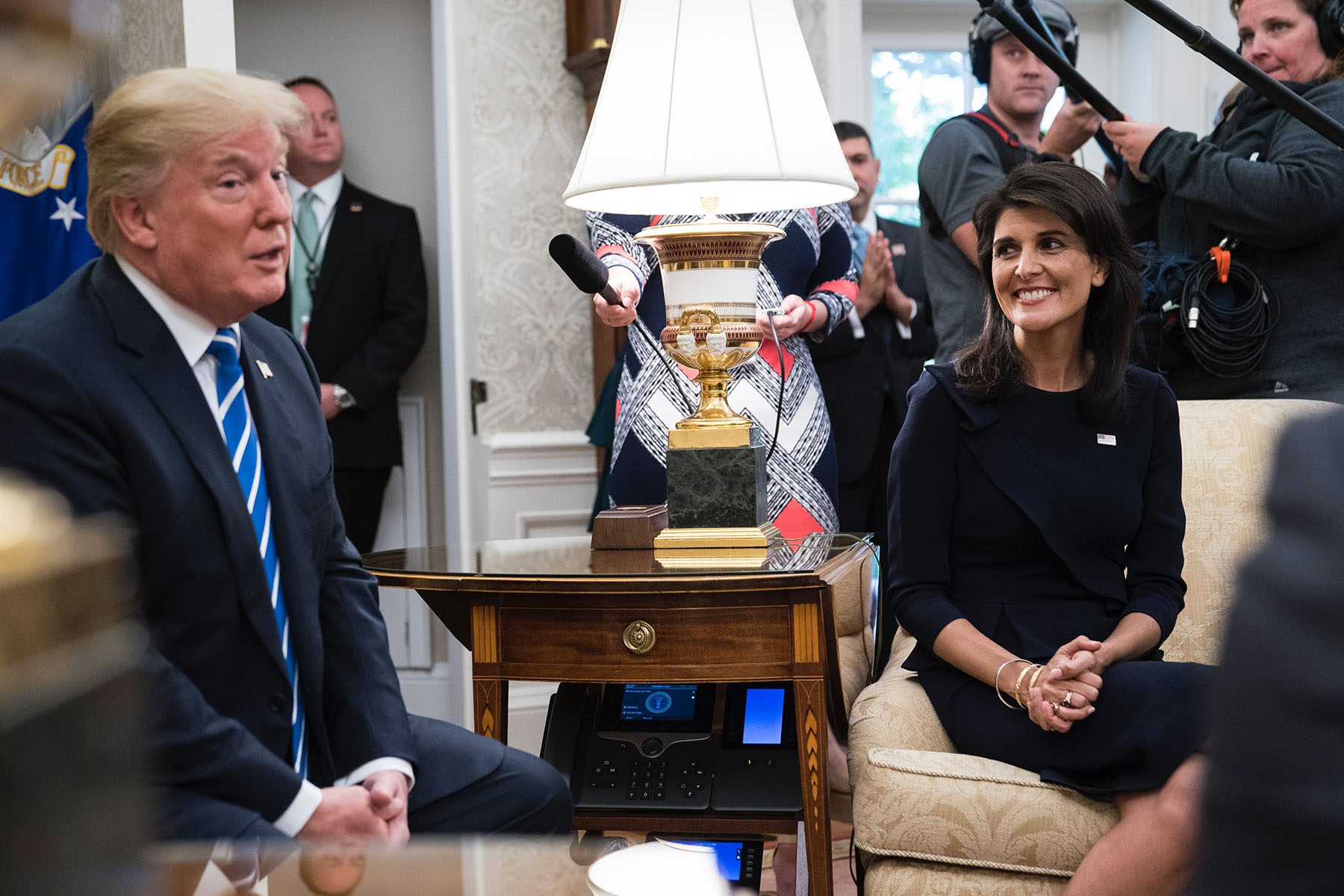 Nikki Haley listens as President Trump speaks during a meeting in the Oval Office of the White House.