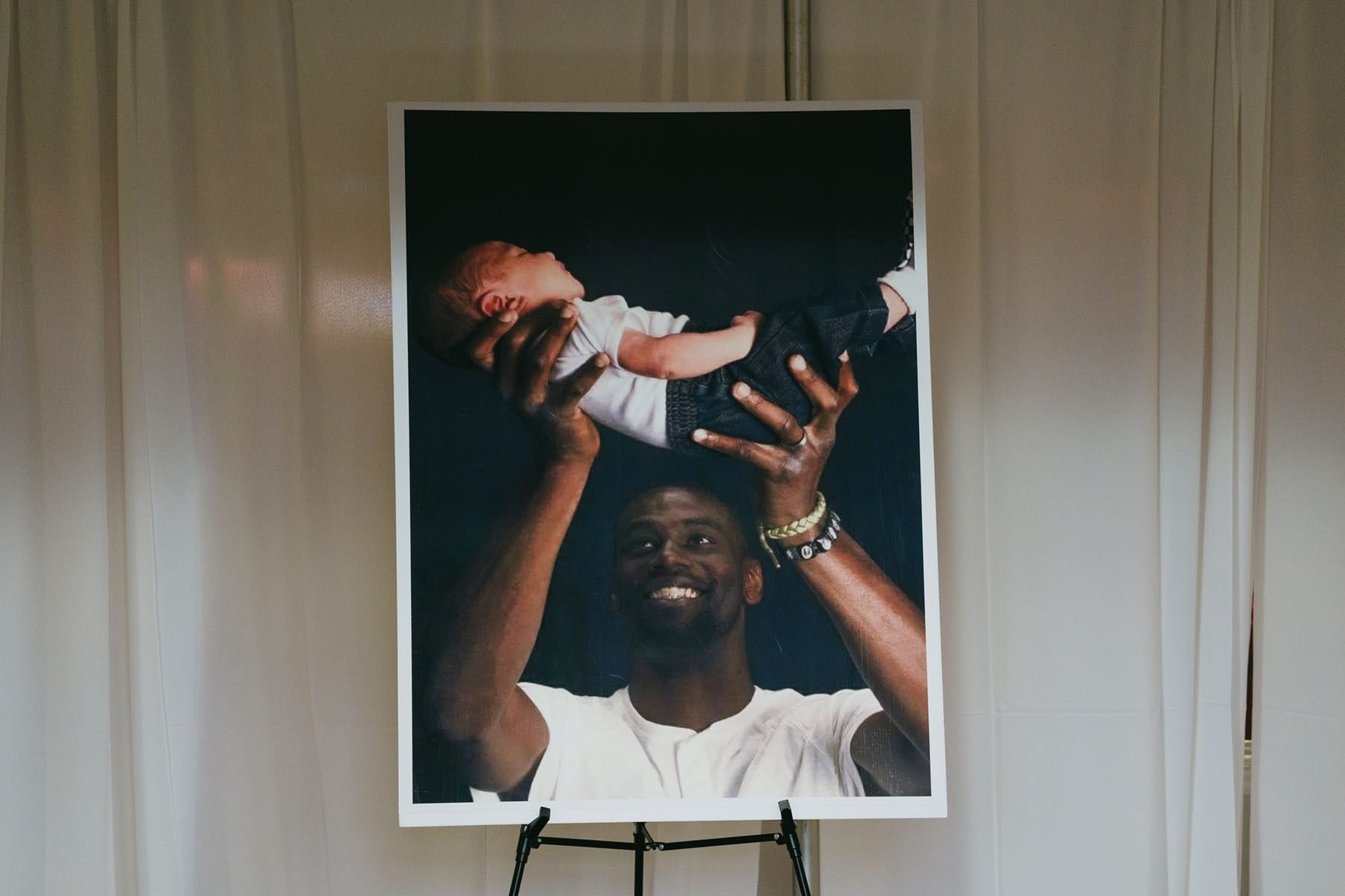 A photograph of Tyre Nichols smiling as he holds his child sits in the foyer of Mississippi Boulevard Christian Church.