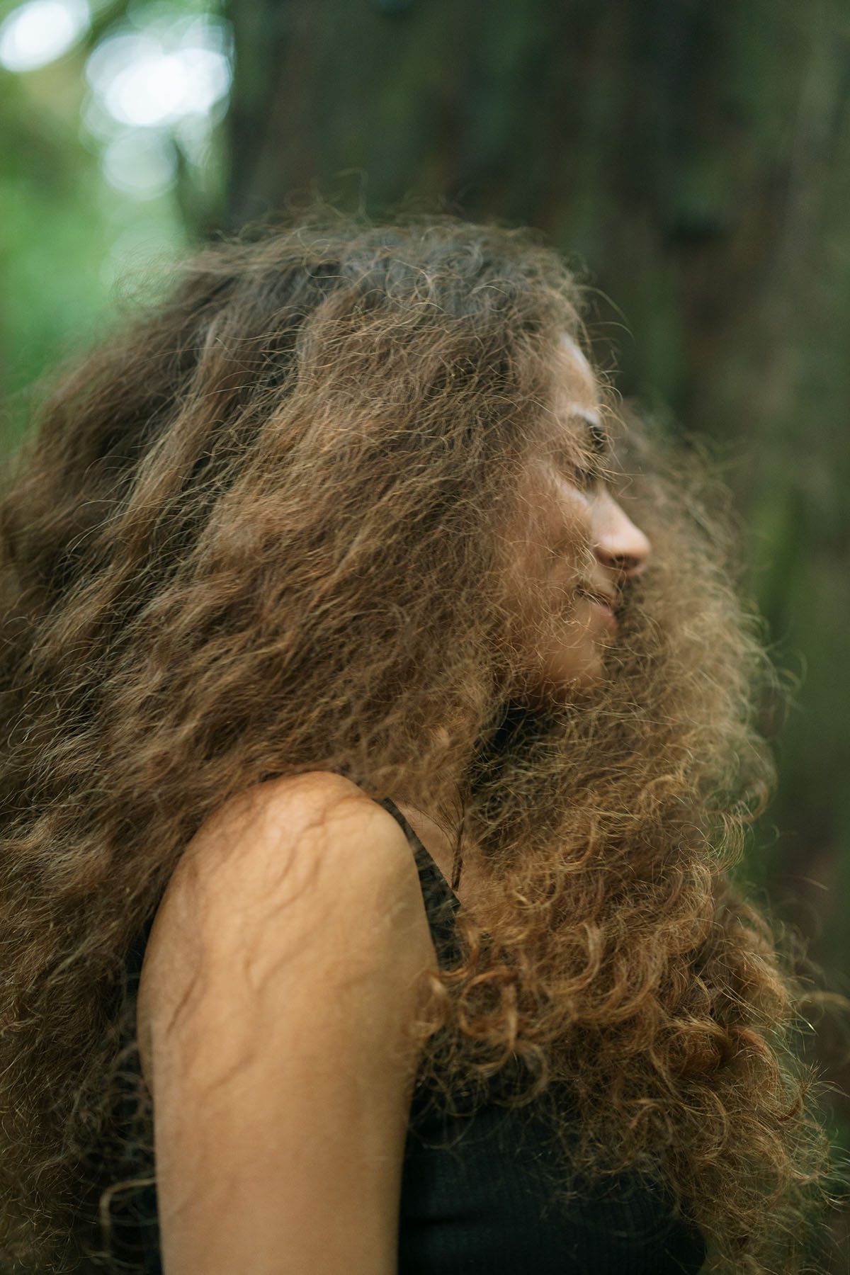 Sage Lenier's hair moves around her as she twirls in the jungle.
