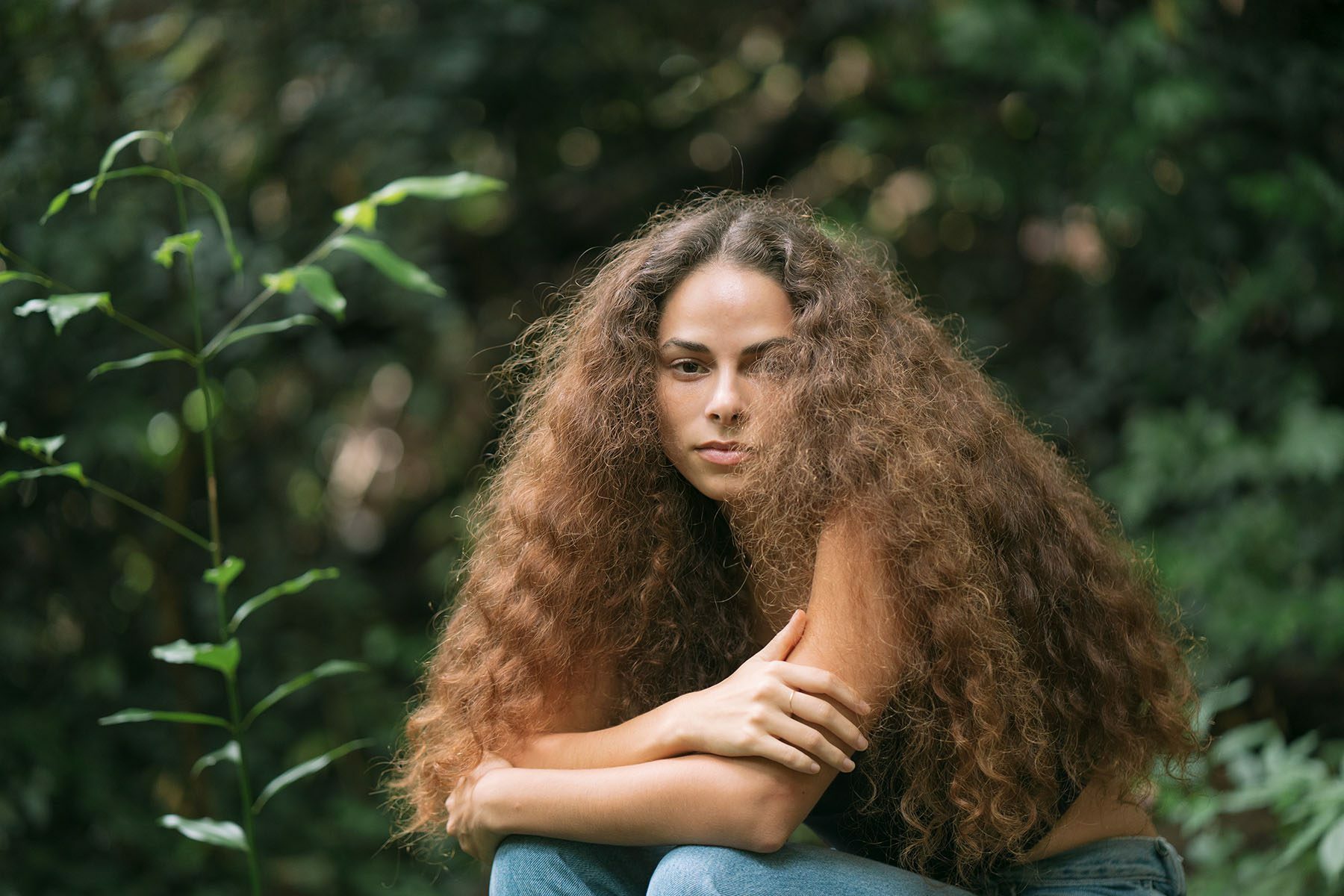 Sage Lenier poses for a portrait in a jungle in Honolulu, Hawaii