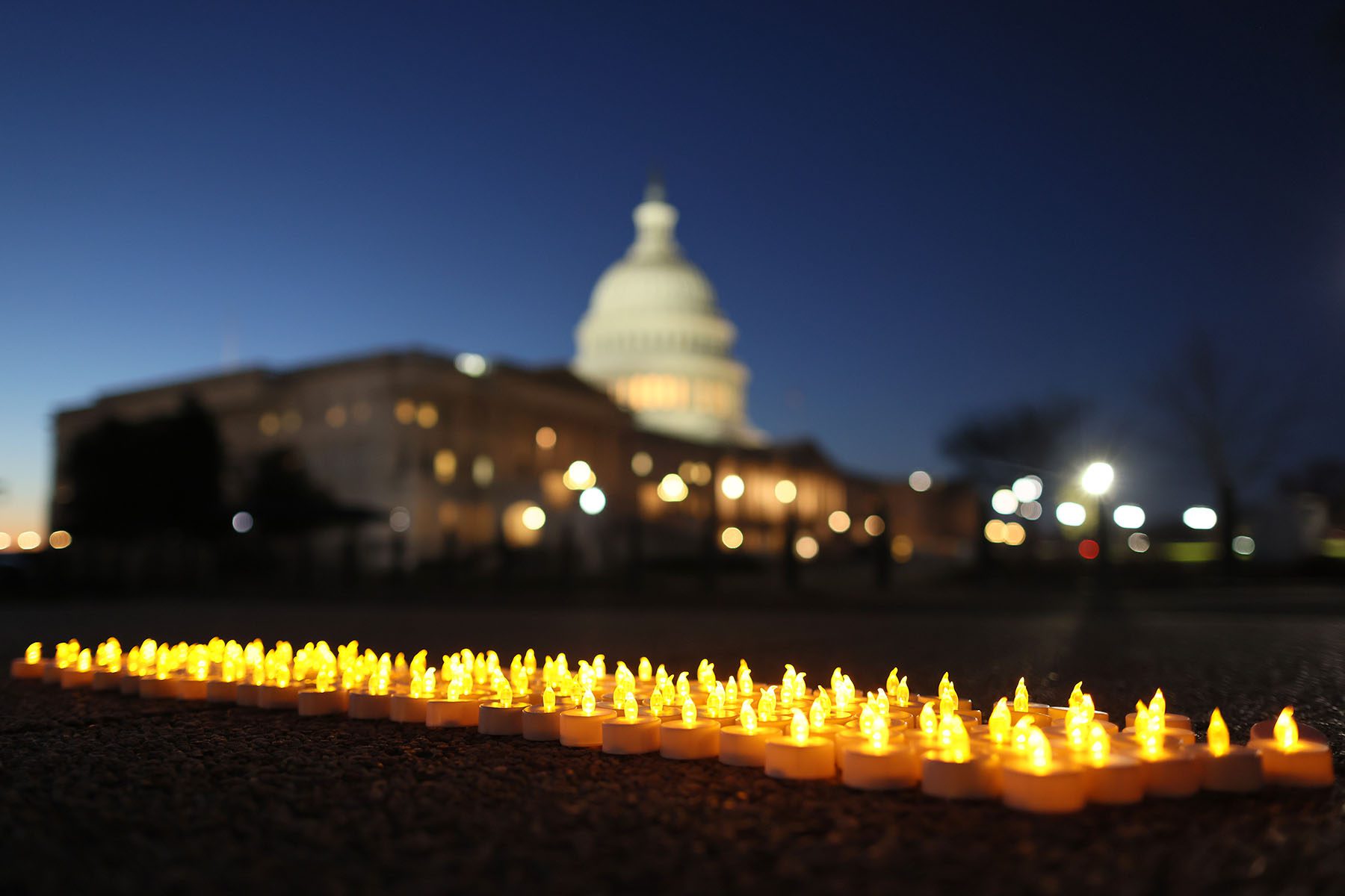 Candles displayed in a row in front of the U.S. Capitol building to commemorate the anniversary of the war in Iraq.
