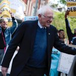 Sen. Bernie Sanders waves after speaking at a Student Loan Forgiveness.