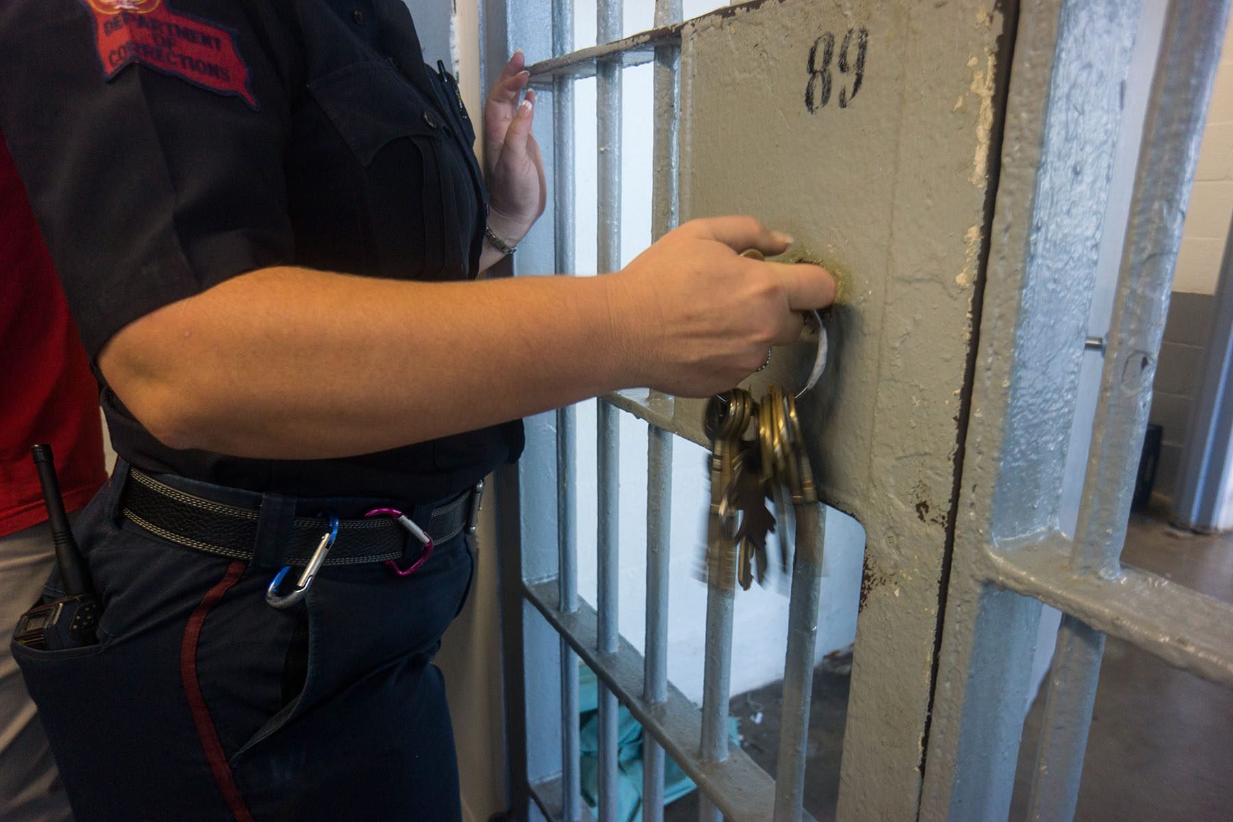 A prison guard opens a locked door with keys inside Angola prison.