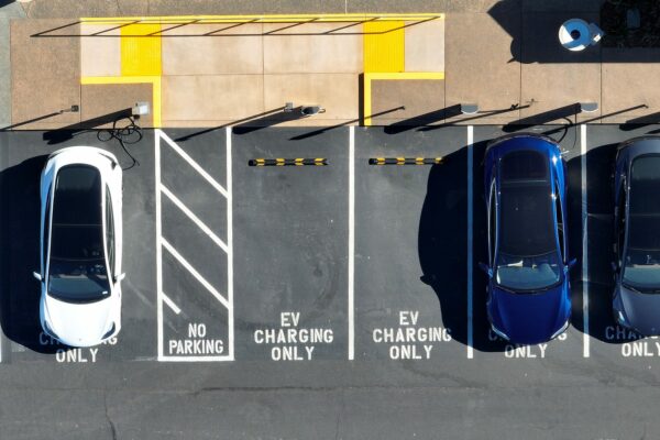 Tesla cars recharge at a Tesla charger station.