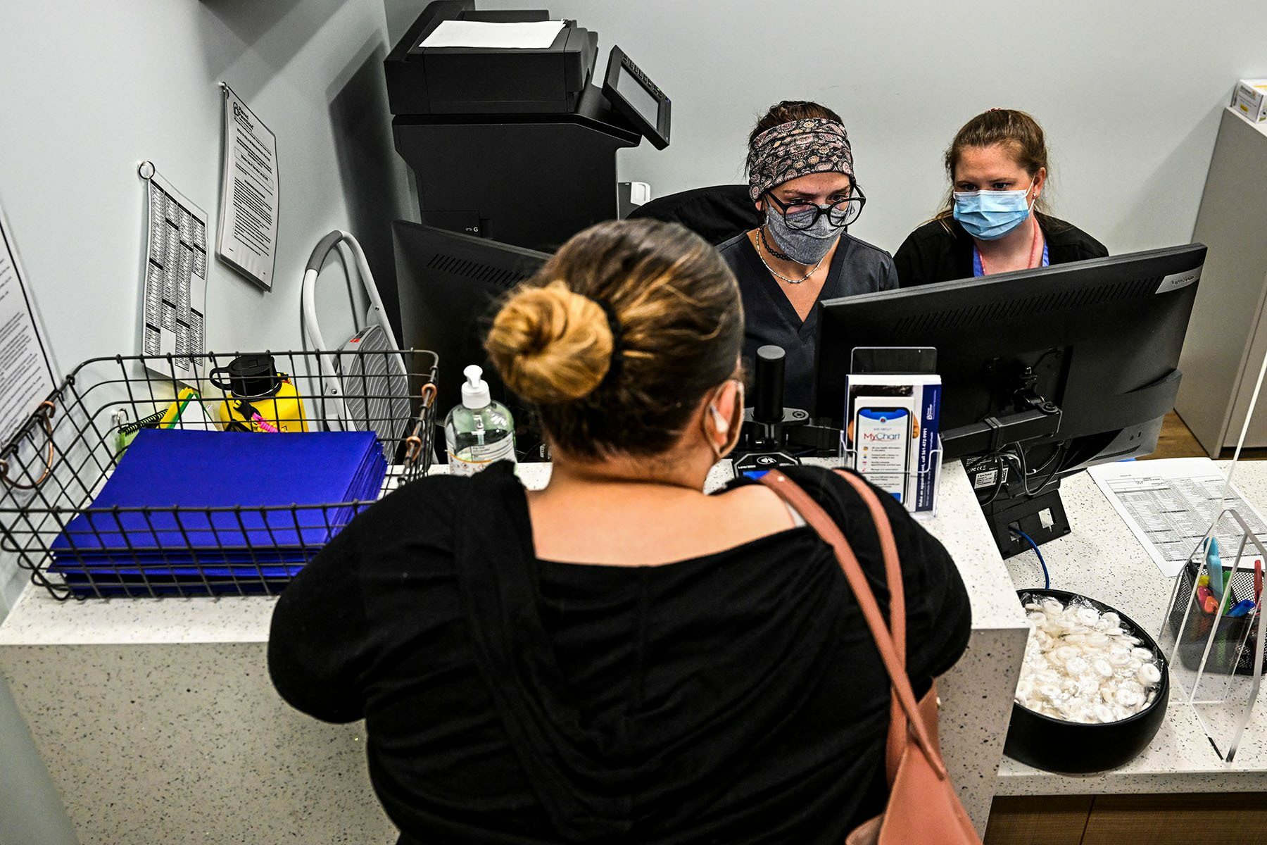 Woman at a counter checking in for her appointment to get an abortion.