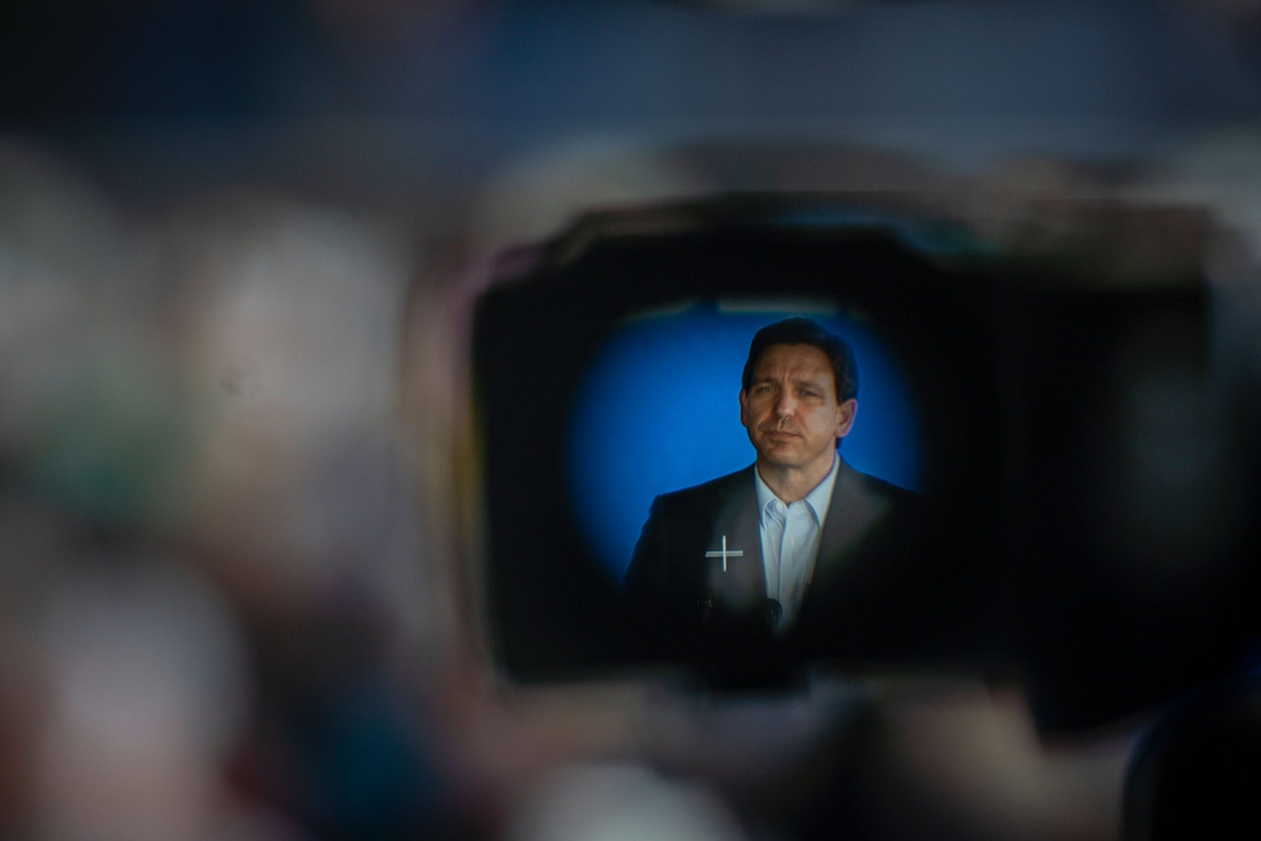 Gov. Ron DeSantis, seen through a TV camera eyepiece, holds a rally in Pinellas Park, Florida in March 2023.