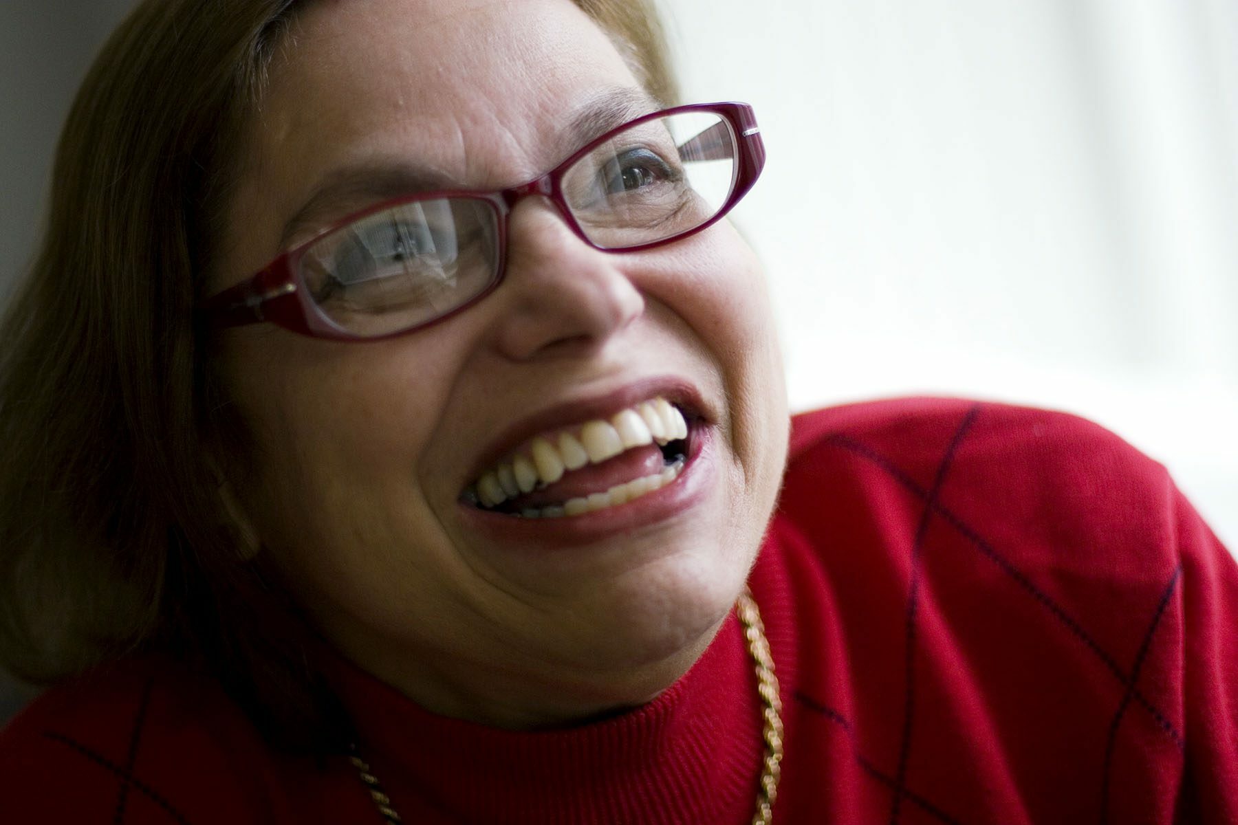 Judy Heumann smiles as she poses for a portrait.