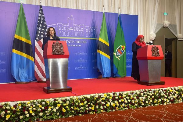 Vice President Kamala Harris speaks at a podium with Tanzania's President Samia Suluhu Hassan.