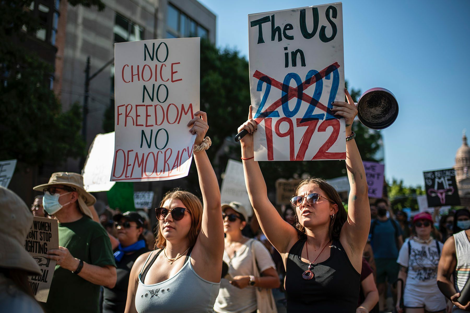 Protesters march while holding signs during an abortion-rights rally in Austin, Texas. The signs read 