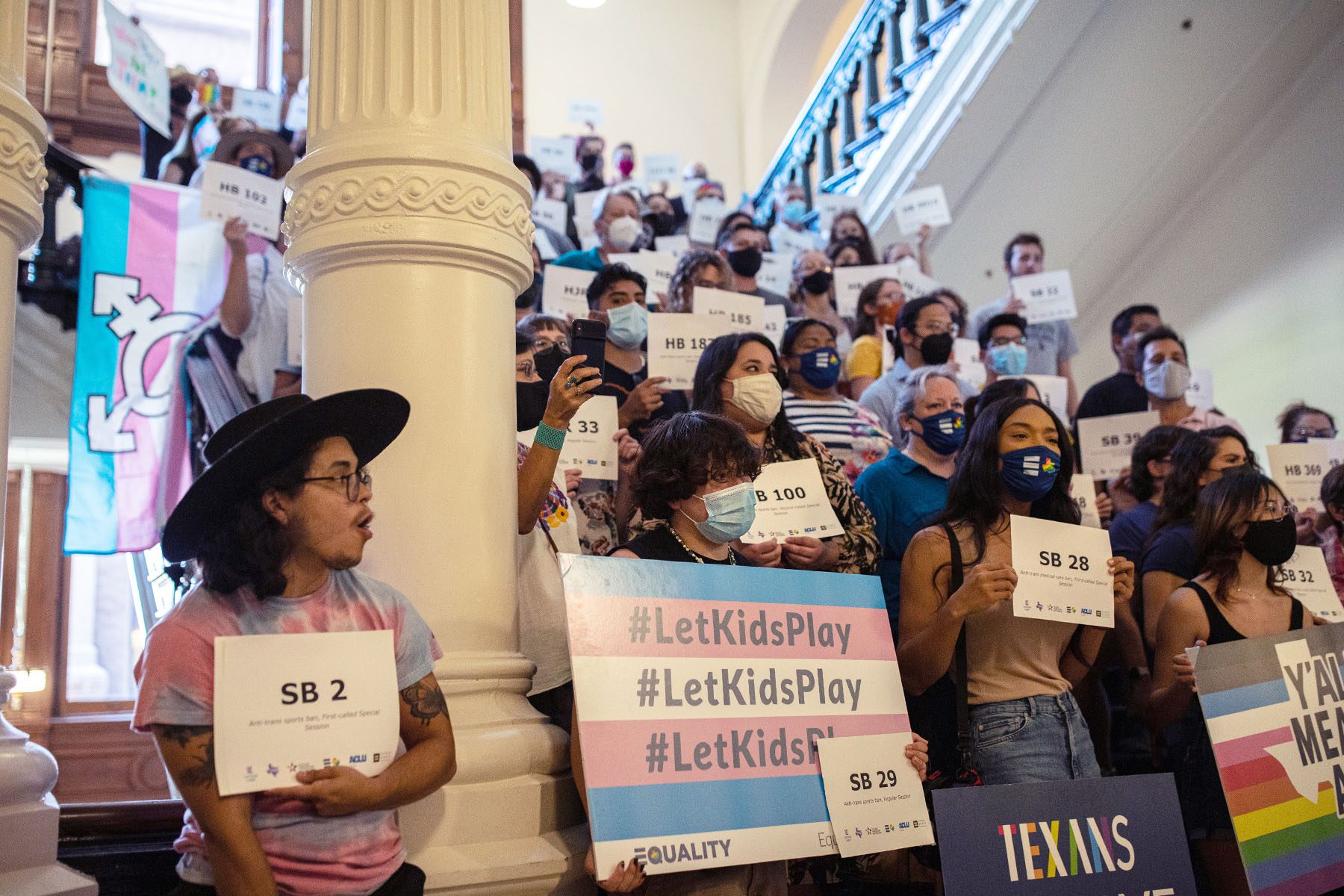 People gather at the Texas State Capitol to protest efforts to pass legislation that would restrict the participation of transgender student athletes in sports.