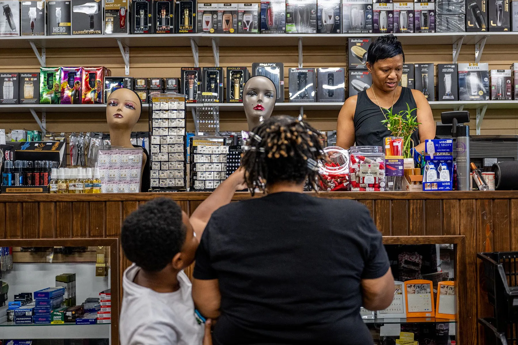 Owner Lynn Gooden assists customers at Mothers Hair Beauty Supply.