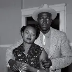 Mamie Till looks at the brutalized body of her son, Emmett Till. She is comforted by Gene Mobley, whom she would later marry.