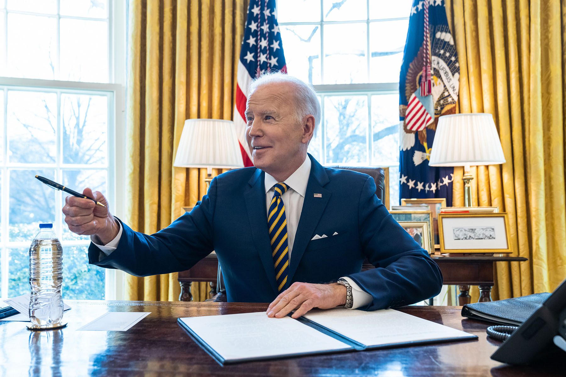 President Biden signs an Executive Order in the Oval Office of the White House.
