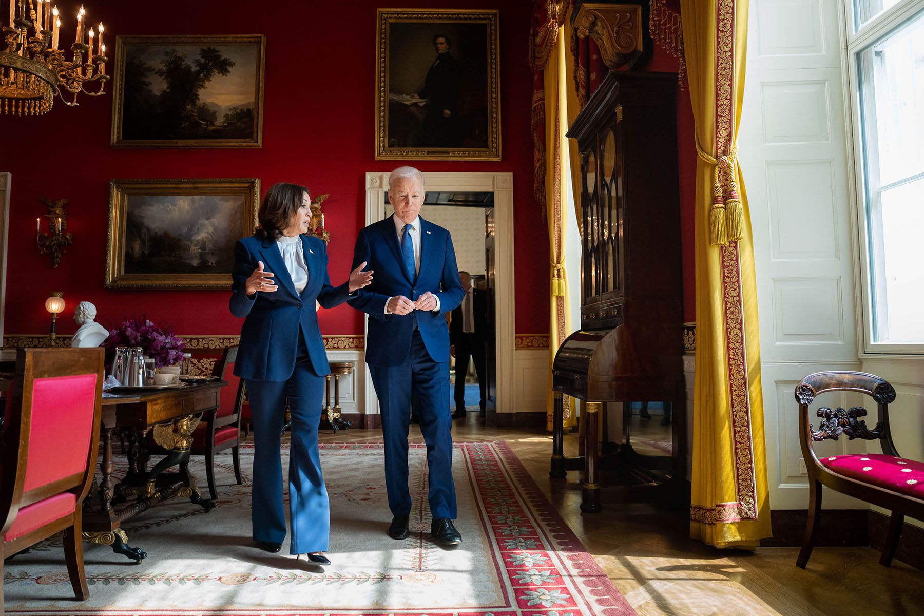 President Biden talks with Vice President Kamala Harris in the Red Room of the White House.