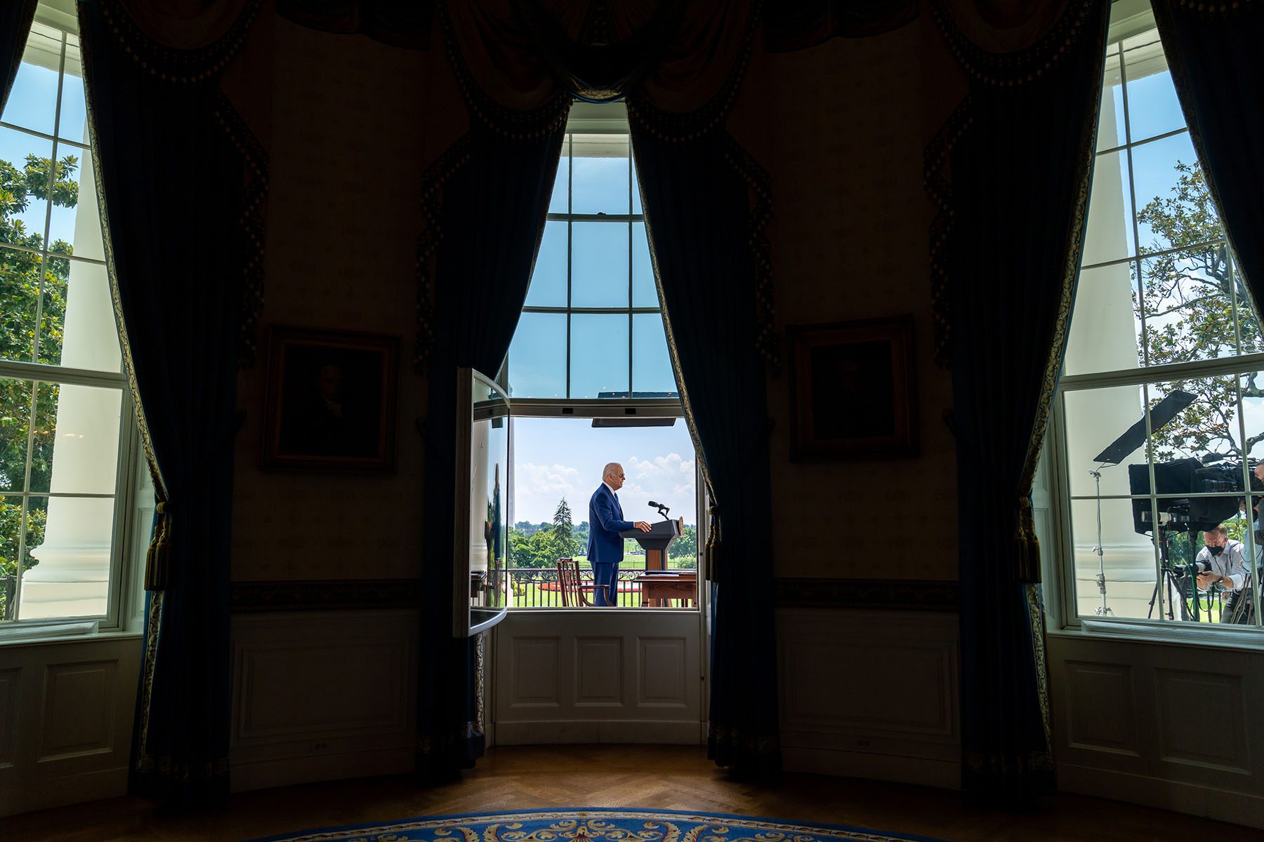 President Joe Biden delivers virtual remarks from the Blue Room Balcony of the White House.