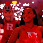 A Rutgers Scarlet Knights cheerleader performs before a college basketball game.
