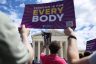 Demonstrators rally in support of abortion rights in front of the Supreme Court. A sign that reads 