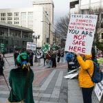 Protesters hold signs opposing the judge's opinion on mifepristone in Seattle