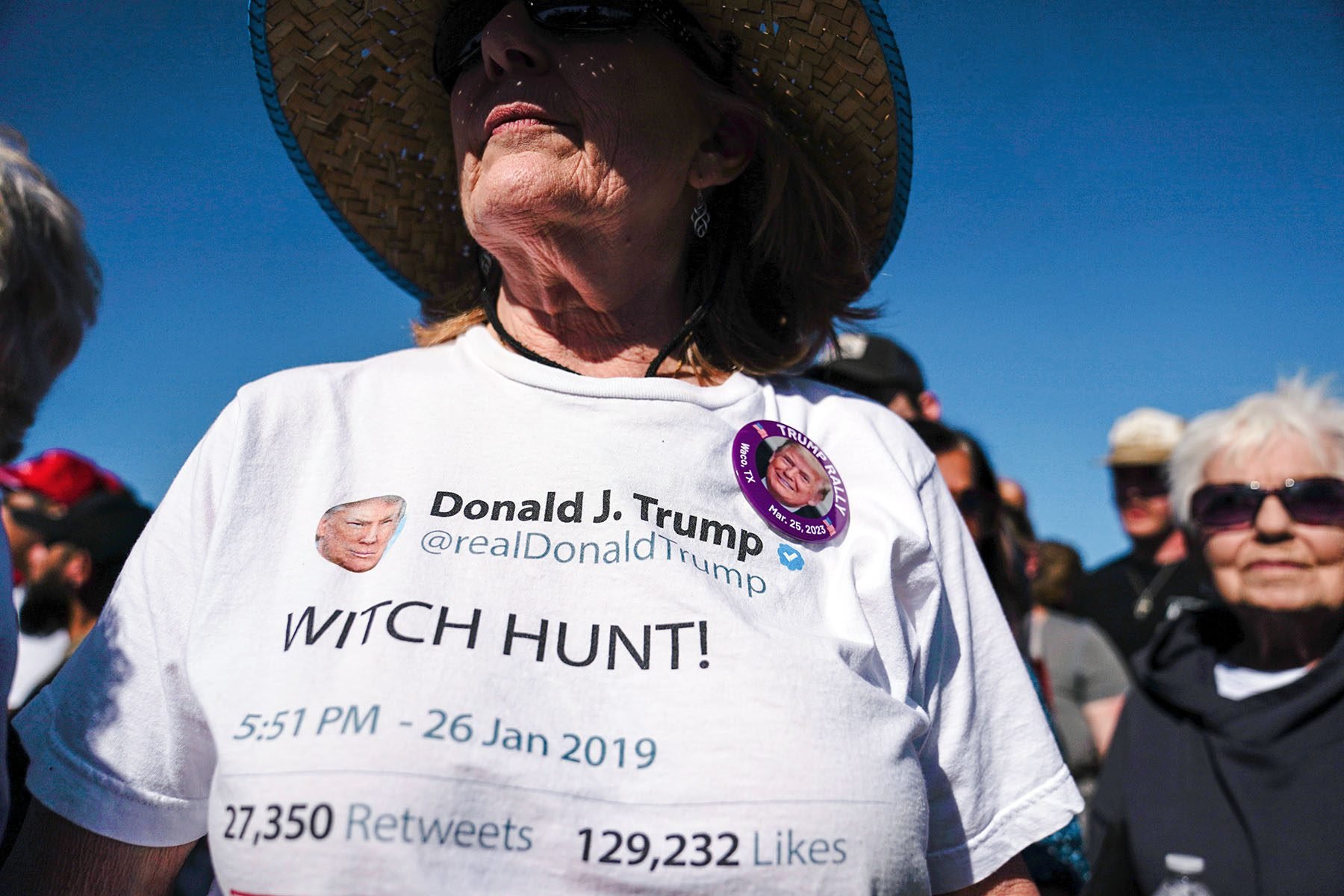 A supporter wearing a shirt with a screenshot of Donald Trump's tweet that reads "WITCH HUNT!" as she waits for him to take the stage at a campaign rally in Waco, Texas.