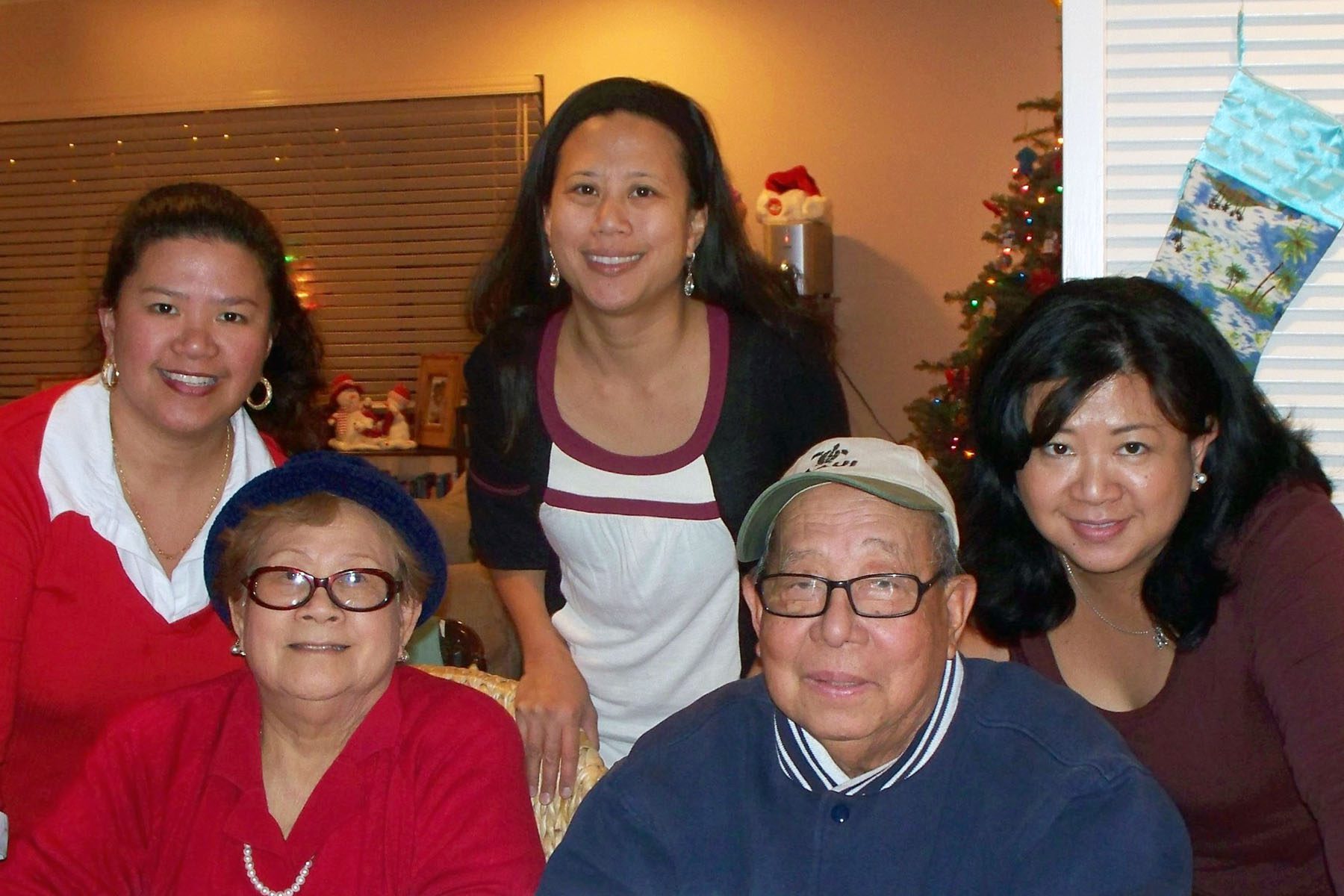 Jocelyn, Jo and Joy Guihama with pose for a family photo with their parents.