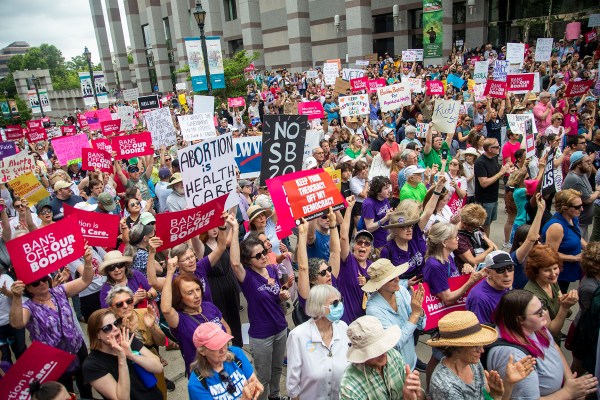 Hundreds of abortion rights supporters rally to watch Gov. Roy Cooper veto new abortion restrictions.