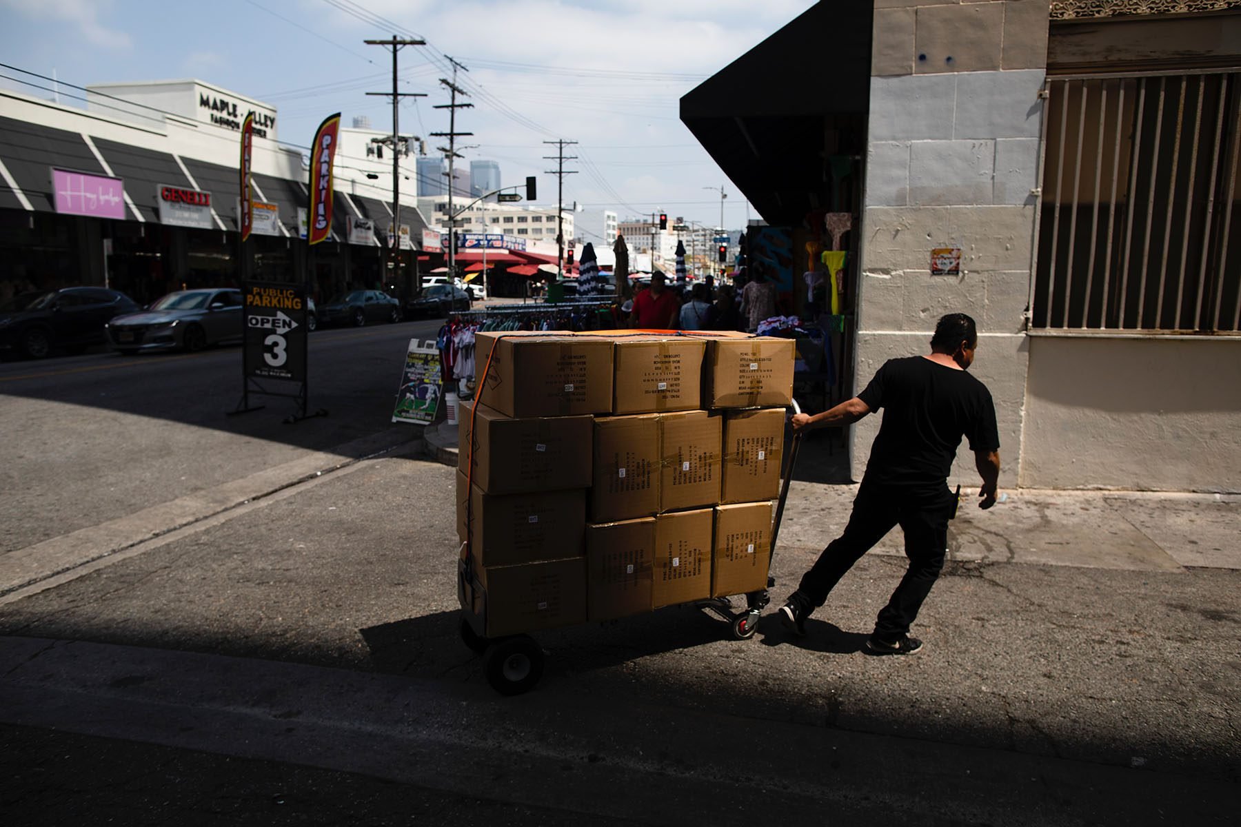 A worker moves boxes in L.A.'s Fashion District.