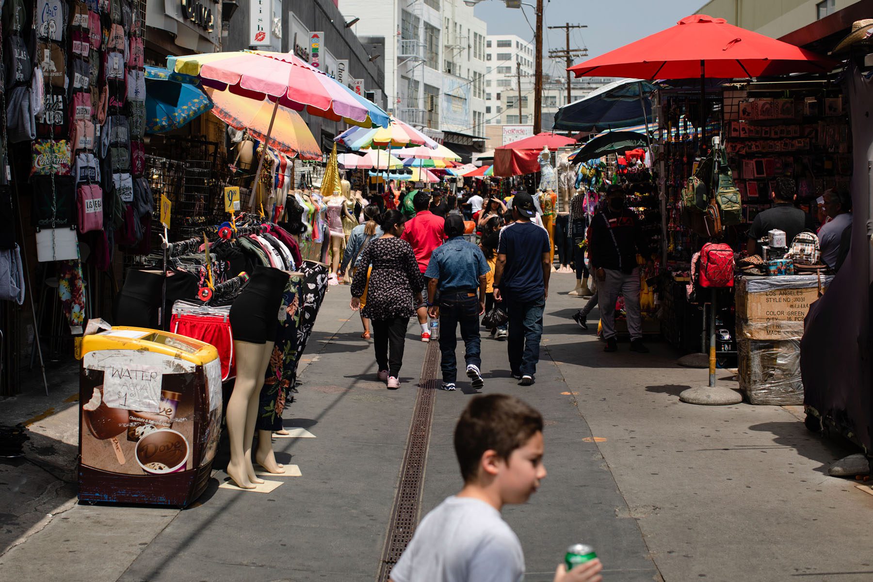 People walk down Santee Alley in the L.A. Fashion District.